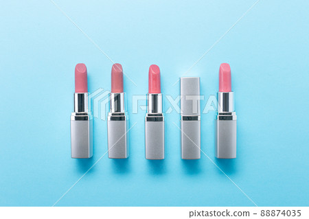 Red and silver lipsticks on blue background, beauty and fashion concept. 88874035