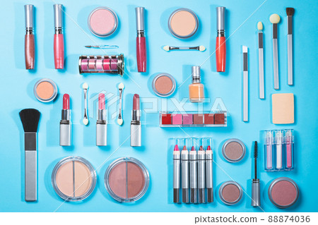 Composition with different makeup products on blue background, top view. beauty products and fashion concept. Composition with different makeup products on blue background, top view. beauty products and fashion concept. 88874036
