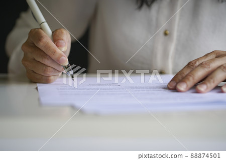 Hand of businesswoman sign on paper document. Hand of businesswoman sign on paper document. 88874501
