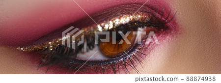 Closeup of female eye with bright pink makeup 88874938