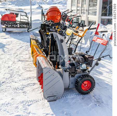 Kemerovo, Russia, February 17, 2022. A new petrol snowplow is on sale. Snow removal mechanism. A device for snow removal at home in winter. 88875369