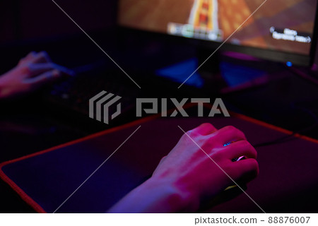 Professional gamer play computer video game in dark room, use neon colored rgb mechanical keyboard, place for cybersport gaming Professional gamer play computer video game in dark room, use neon colored rgb mechanical keyboard, place for cybersport gaming 88876007
