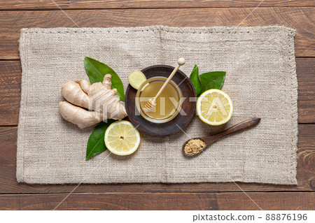 Ginger, honey and lemon on wooden base. Natutal food and brevage concept. Ginger, honey and lemon on wooden base. Natutal food and brevage concept. 88876196