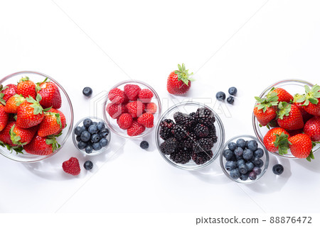 Berries in glass bowls on white background. Top view. Berries in glass bowls on white background. Top view. 88876472