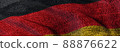 Close of grunge German flag. Grunge flag of Germany abstract 3D illustration. Dark and grungy national flag of the Federal Republic of Germany on denim fabric texture for web banner 3D rendering. 88876622