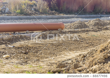 Laying pipes under the road culvert during road construction Laying pipes under the road culvert during road construction 88877498