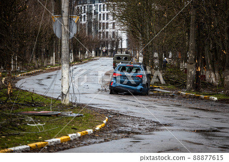 Irpin, Kyev region  Ukraine - 09.04.2022: Cities of Ukraine after the Russian occupation. On the streets of Irpin. Shot cars. Irpin, Bucha, Gostomel. 88877615