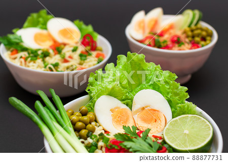 Noodle Dish with Green Onions, Eggs, Green Pea, Red Hot Pepper, Greens and Lime Noodle Dish with Green Onions, Eggs, Green Pea, Red Hot Pepper, Greens and Lime 88877731