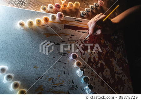 person hand drawing picture with painting by numbers with brush, acrylic, macro person hand drawing picture with painting by numbers with brush, acrylic, macro 88878729