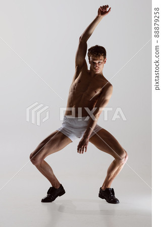 Contemp dance, performance. Young flexible shirtless man in underwear dancing isolated on gray background. Art, music, beauty. Healthy lifestyle concept 88879258