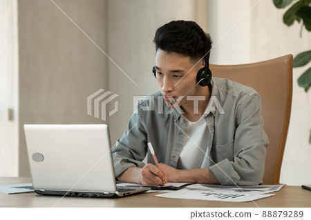 Asian assistant writes down payment details helping customer 88879289