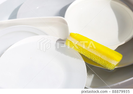 Dish washing, Dirty dishes soaking in kitchen sink. 88879935