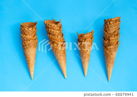 Empty ice cream cone on blue background. 88879941