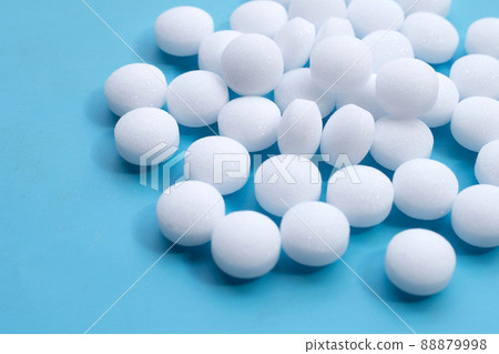 Naphthalene mothballs on blue backgrond. 88879998