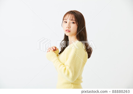Young woman in yellow knit girly fashion bangs see-through bang Young woman in yellow knit girly fashion bangs see-through bang 88880263