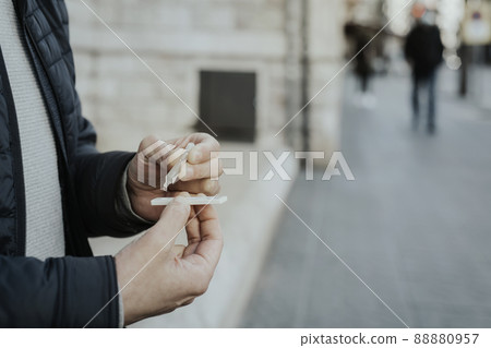 man is doing a covid-19 rapid test on the street 88880957