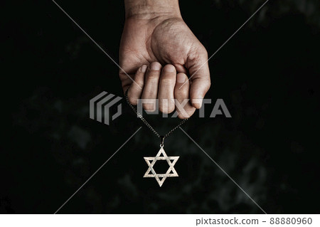 man with a pendant in the shape of the star of david 88880960