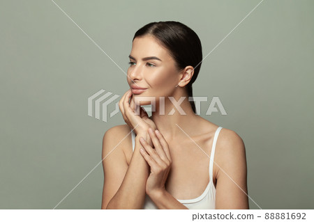 Beautiful smiling woman with natural makeup and clean skin on grey background 88881692