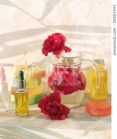 Natural soap, fresh red rose flowers, aroma oil, healthy tinctures on a wooden window sill, spa, organic cosmetics for body care and relaxation Natural soap, fresh red rose flowers, aroma oil, healthy tinctures on a wooden window sill, spa, organic cosmetics for body care and relaxation 88881943