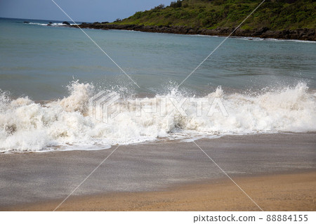 Waves rushing to the sandy beach Waves rushing to the sandy beach 88884155