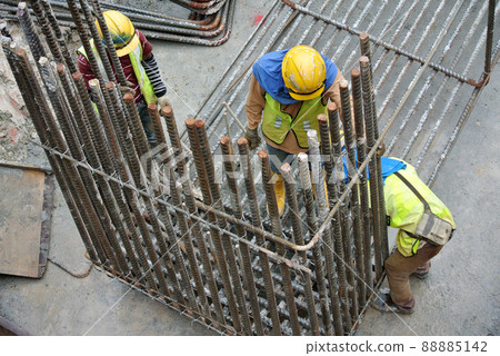 JOHOR, MALAYSIA -APRIL 14, 2015: Construction workers fabricating pile cap steel reinforcement bar at the construction site JOHOR, MALAYSIA -APRIL 14, 2015: Construction workers fabricating pile cap steel reinforcement bar at the construction site 88885142