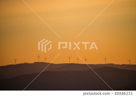 Wind power stations - wind turbines on the horizon, in the mountains 88886231