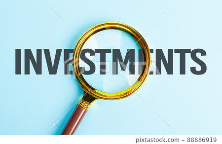 Successful business investments. Investment search concept. Magnifying glass over text - investments Successful business investments. Investment search concept. Magnifying glass over text - investments 88886919