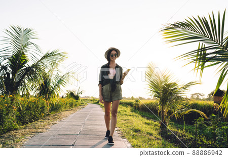 Millennial blogger with mobile phone strolling 88886942