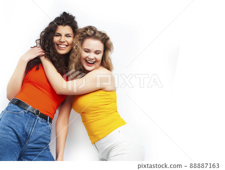young pretty teenage girls friends with blond and brunette curly hairs posing cheerful isolated on white background, lifestyle people concept young pretty teenage girls friends with blond and brunette curly hairs posing cheerful isolated on white background, lifestyle people concept 88887163