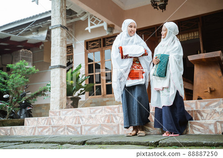 asian muslim with hijab standing in front of the house asian muslim with hijab standing in front of the house 88887250
