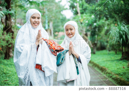 portrait of mother and daughter wearing mukena portrait of mother and daughter wearing mukena 88887316