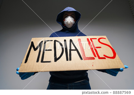 'Media lies' painted on placard in hands of protester man 'Media lies' painted on placard in hands of protester man 88887569