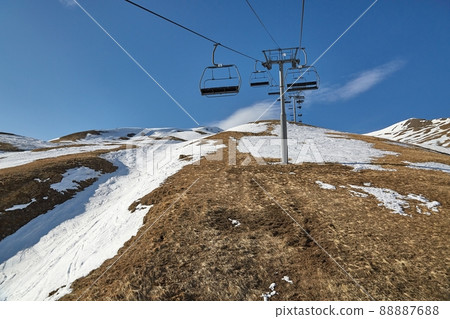 Ski lift at a ski resort with little snow Ski lift at a ski resort with little snow 88887688