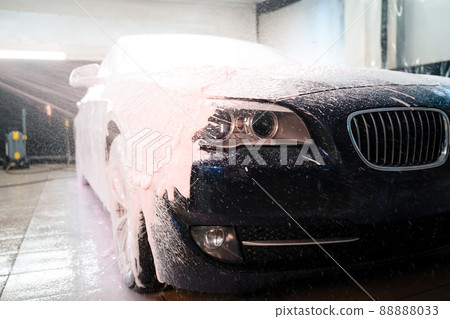 Applying foam to the car. Professional auto wash Applying foam to the car. Professional auto wash 88888033
