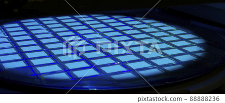 Silicon wafer with chips in UV lighting. Neon. Ultraviolet Lithography. Silicon wafer with chips in UV lighting. Neon. Ultraviolet Lithography. 88888236