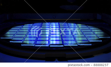 Silicon wafer with chips in UV lighting. Neon. Ultraviolet Lithography. 88888237