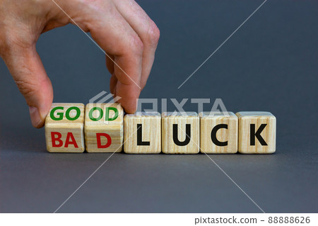 Good or bad luck symbol. Businessman turns wooden cubes and changes words 'bad luck' to 'good luck'. Beautiful grey background, copy space. Business and good or bad luck concept. 88888626