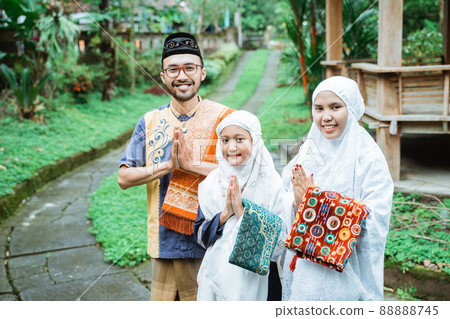 muslim family greeting gesture while looking at the camera 88888745