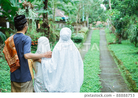 muslim family with kid walking together and hold hand muslim family with kid walking together and hold hand 88888753