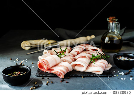 Raw slices of streaky bacon with spices, olive oil and tools for grill 88888980