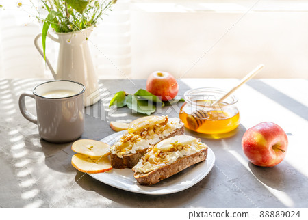 Bread slices with cottage cheese, honey, apples and nuts. Breakfast concept Bread slices with cottage cheese, honey, apples and nuts. Breakfast concept 88889024