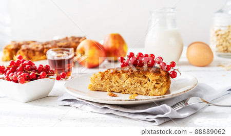Homemade healthy apple pie with oats, cinnamon and maple syrup as a sweetener, decorated with red currants Homemade healthy apple pie with oats, cinnamon and maple syrup as a sweetener, decorated with red currants 88889062