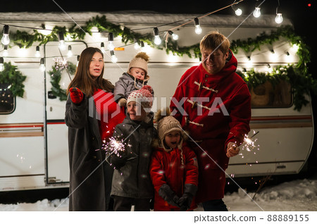 Happy parents with three sons celebrating christmas in motorhome.  88889155