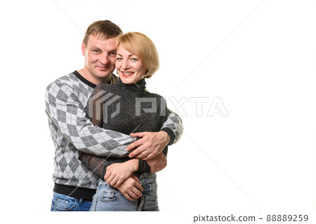 Portrait of a young couple, a man hugging a woman, isolated on a white background 88889259