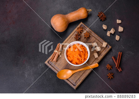 Pumpkin carrot baby puree in bowl on a dark background Pumpkin carrot baby puree in bowl on a dark background 88889283