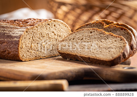 Sliced loaf of bread on cutting board. Sliced loaf of bread on cutting board. 88889928