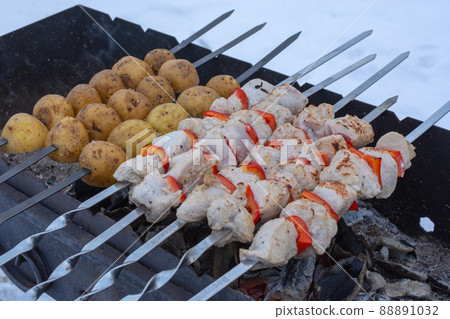 cooking barbecue and potatoes on the grill cooking barbecue and potatoes on the grill 88891032