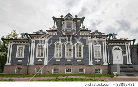 View of facade of wooden house of Decembrist Sergei Trubetskoy in Irkutsk in summer in cloudy weather. 88892451