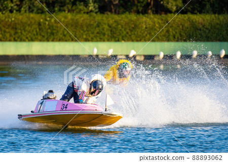 A boat race player who turns a corner while raising a splash of water 88893062
