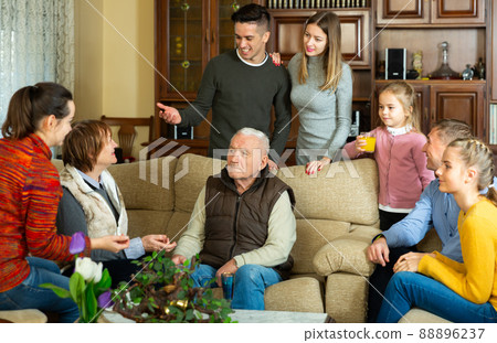 Happy family having conversation together Happy family having conversation together 88896237